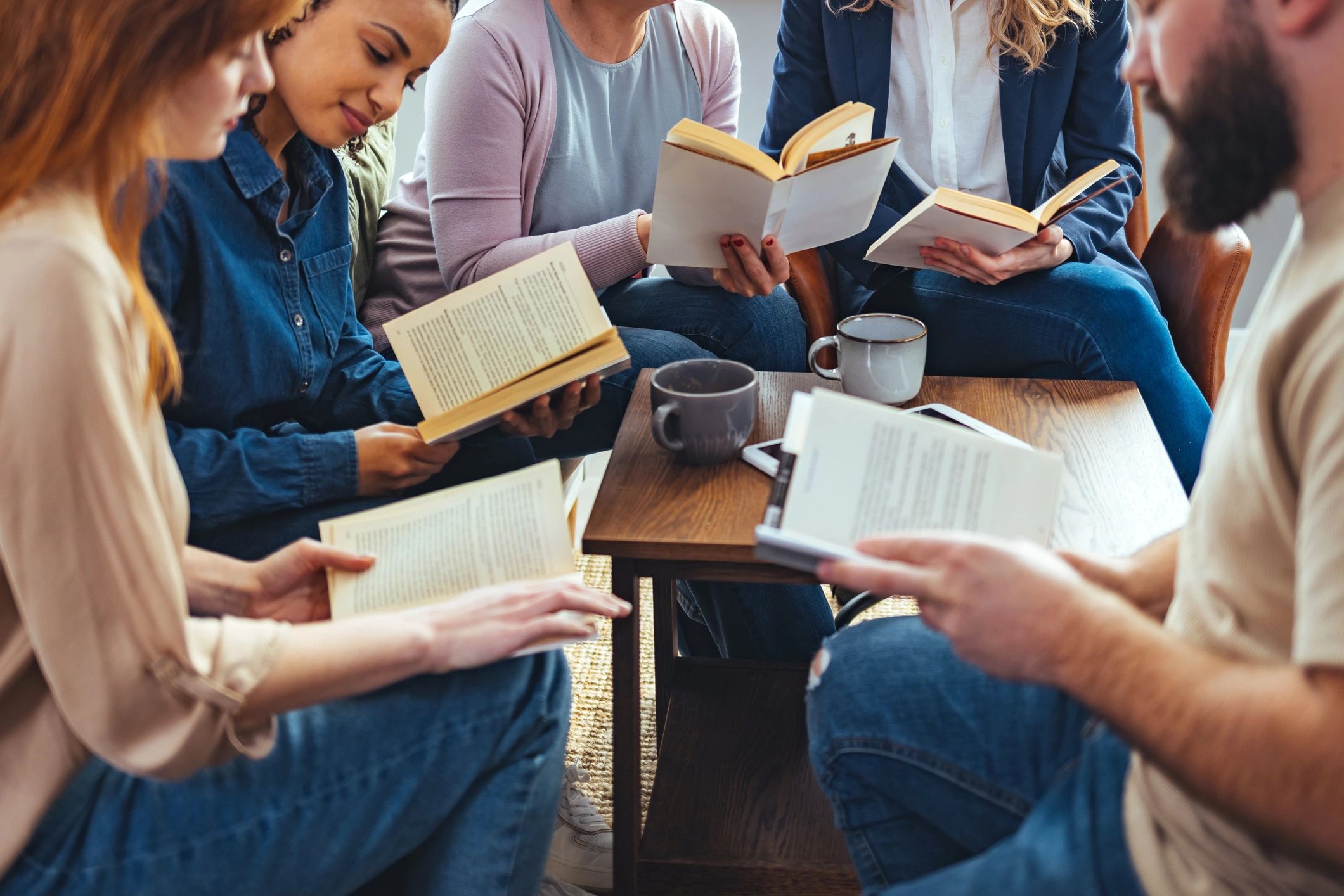 Group learning around a table with books