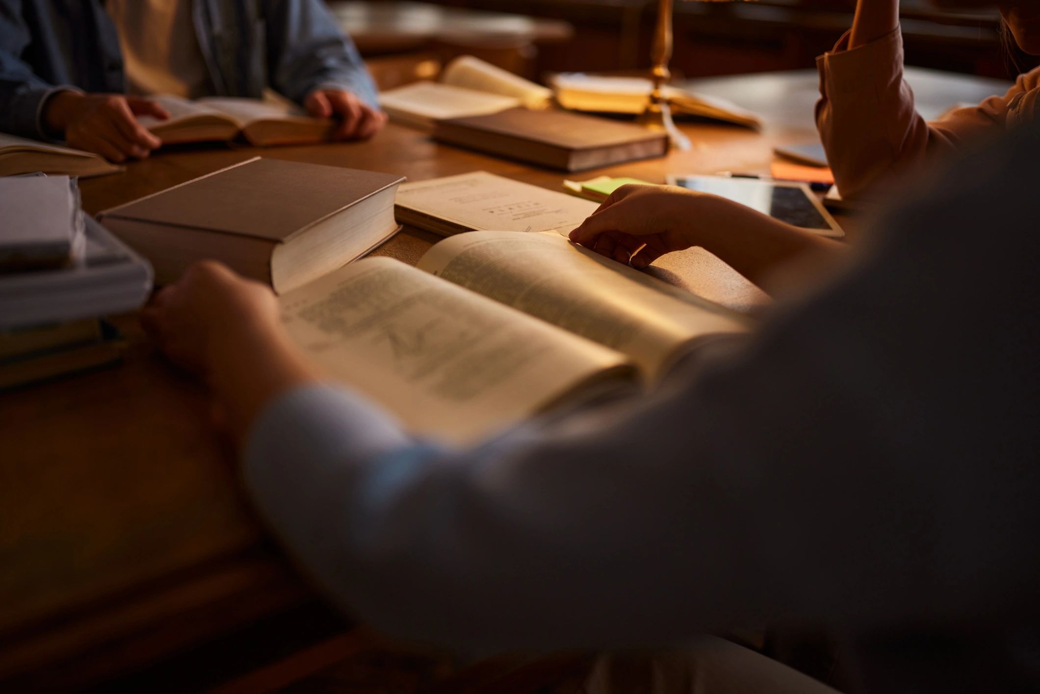 Student reading a book in a library