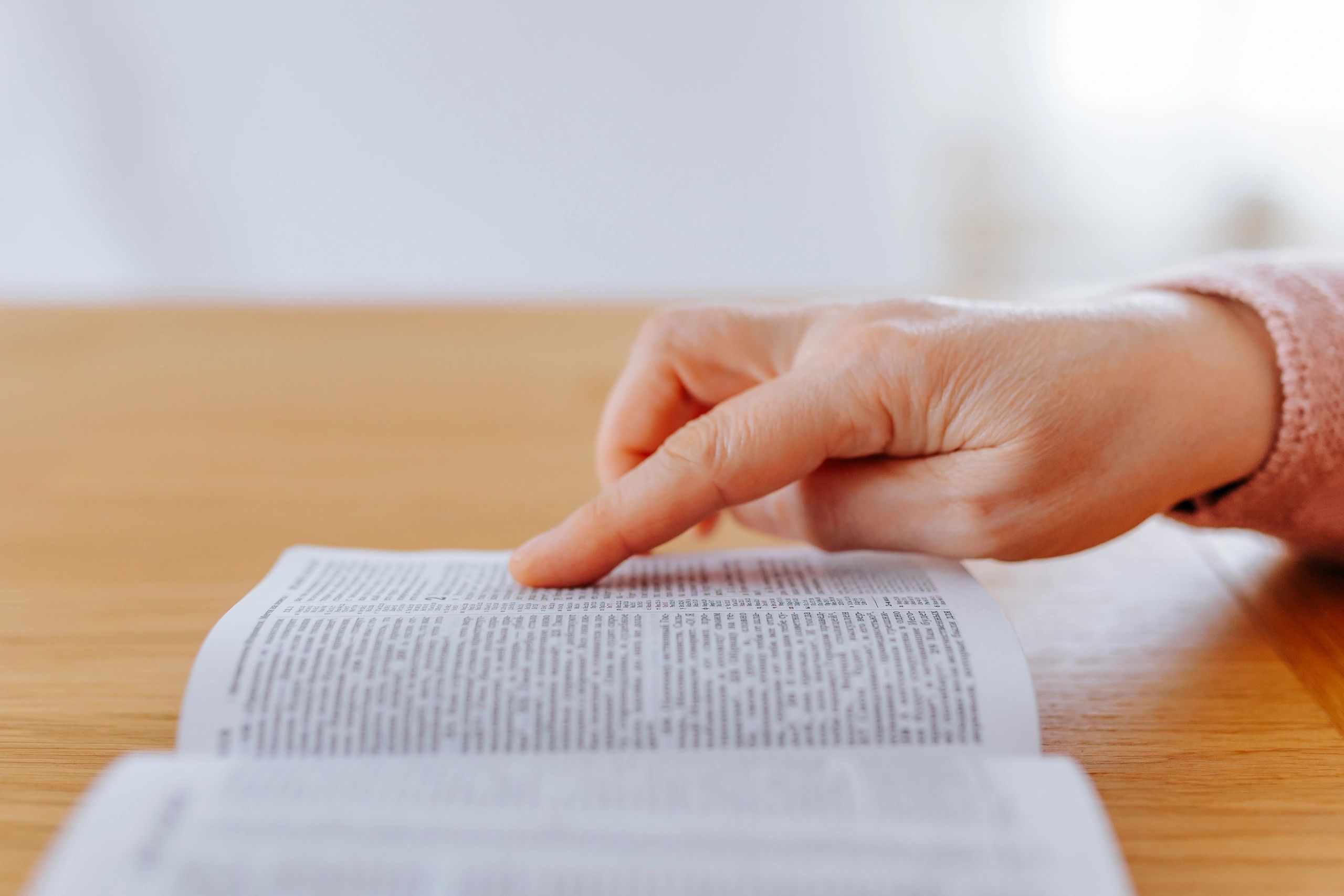 Hands holding an open book for reading