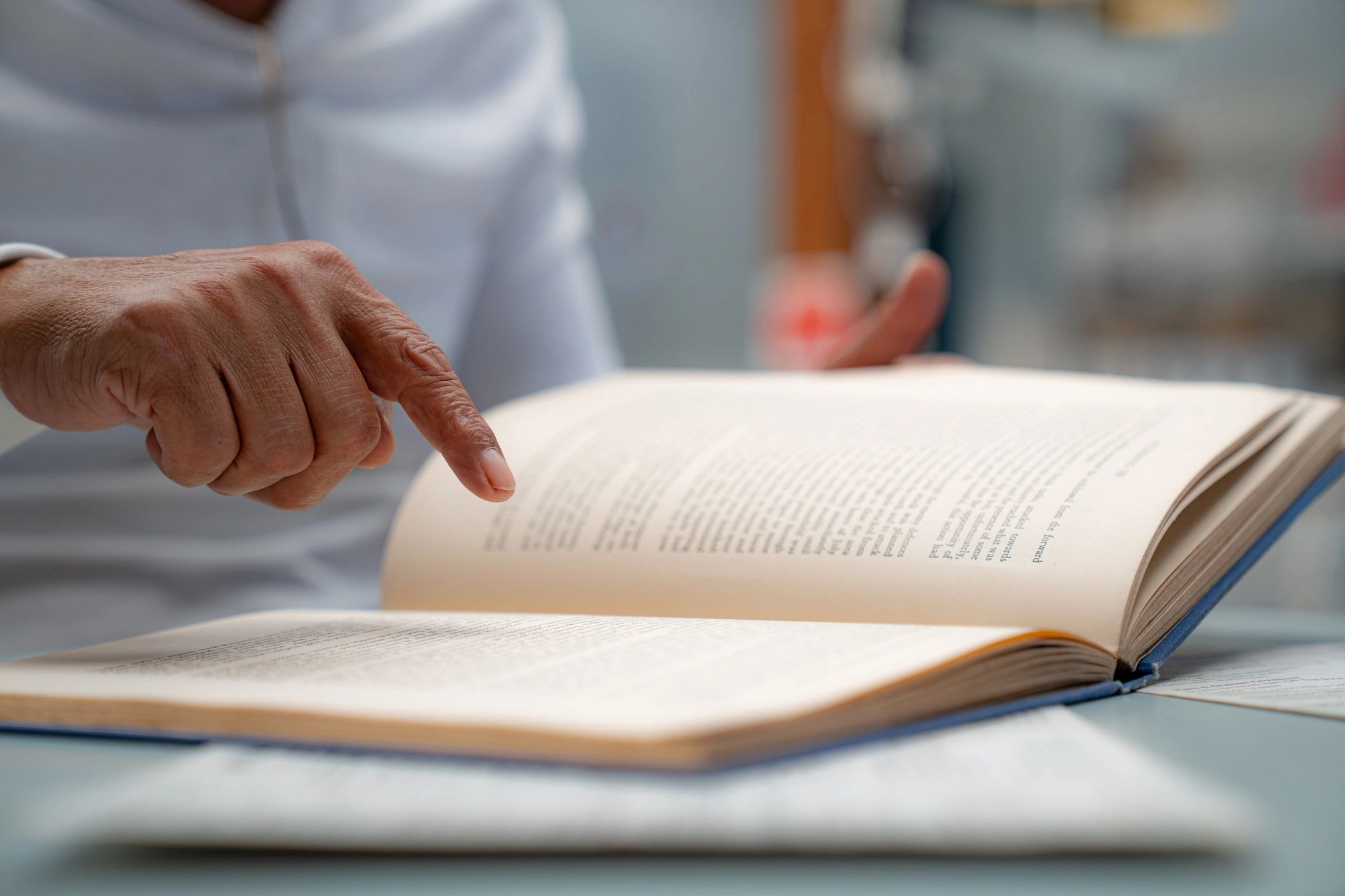Close-up of a person studying an open book